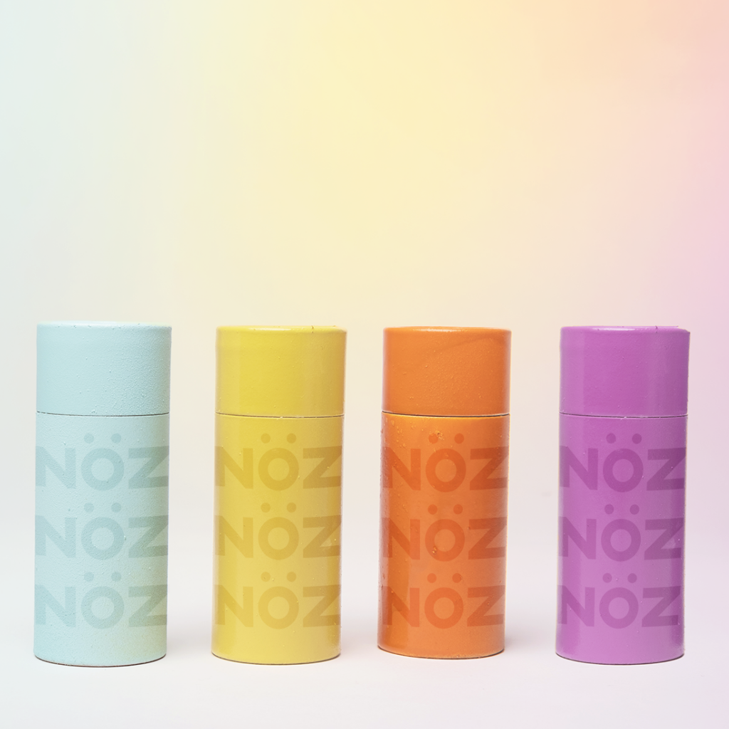 Front view of the blue, yellow, orange, and purple sunscreen bottles side by side