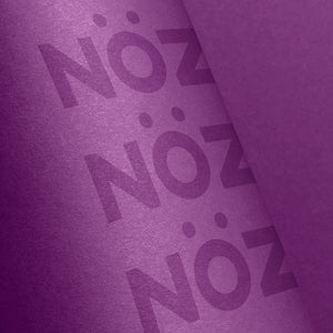 Close-up of the purple Noz sunscreen bottle